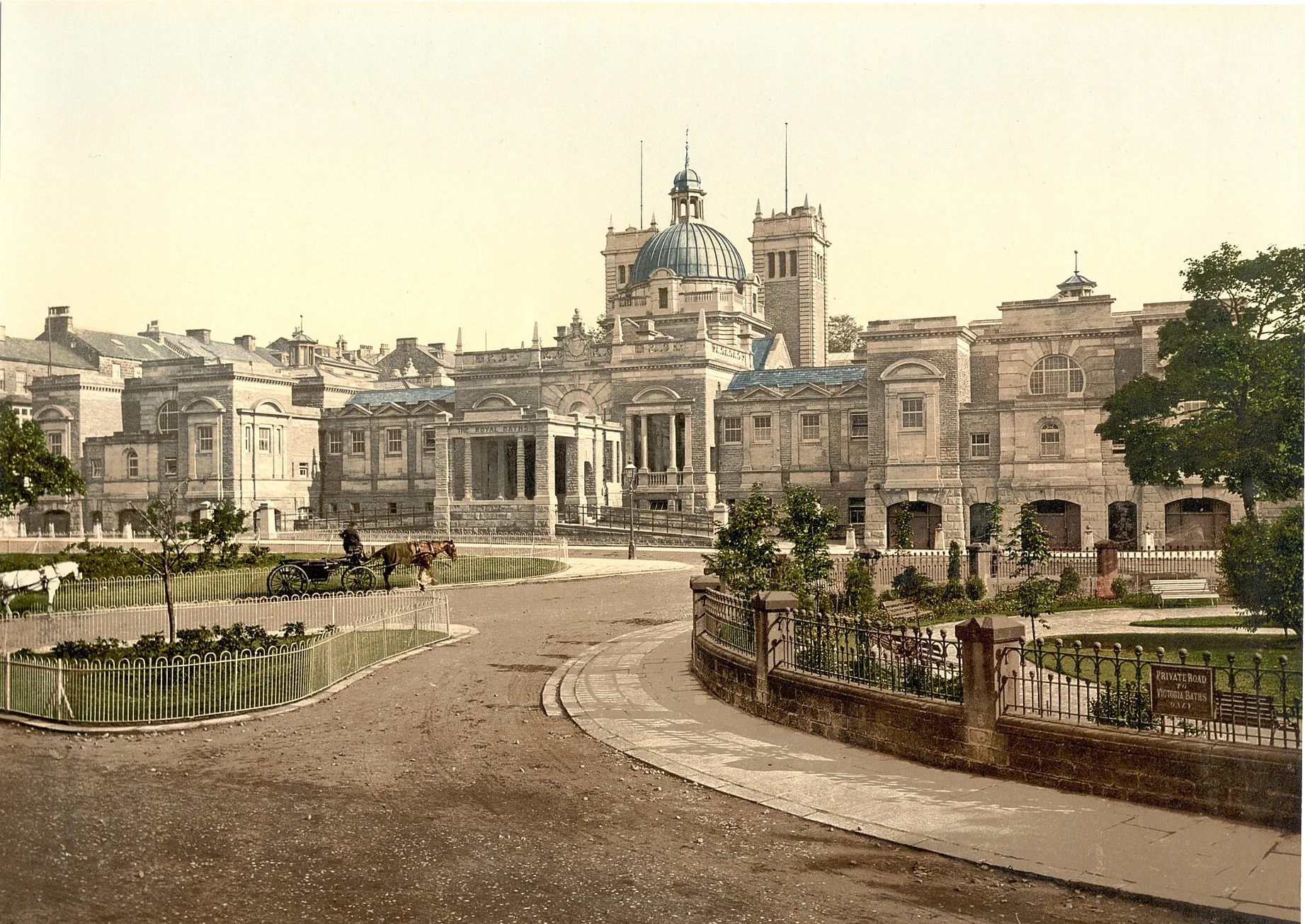 Colour photochrom print of the Royal Baths in Harrogate with a horse-drawn carriage on the drive